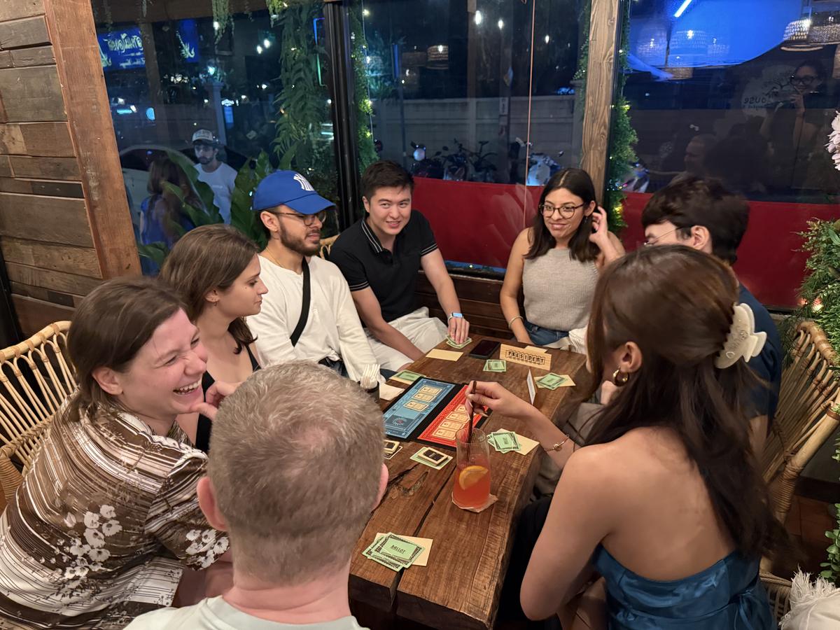 Friends laughing over a board game at Game Night