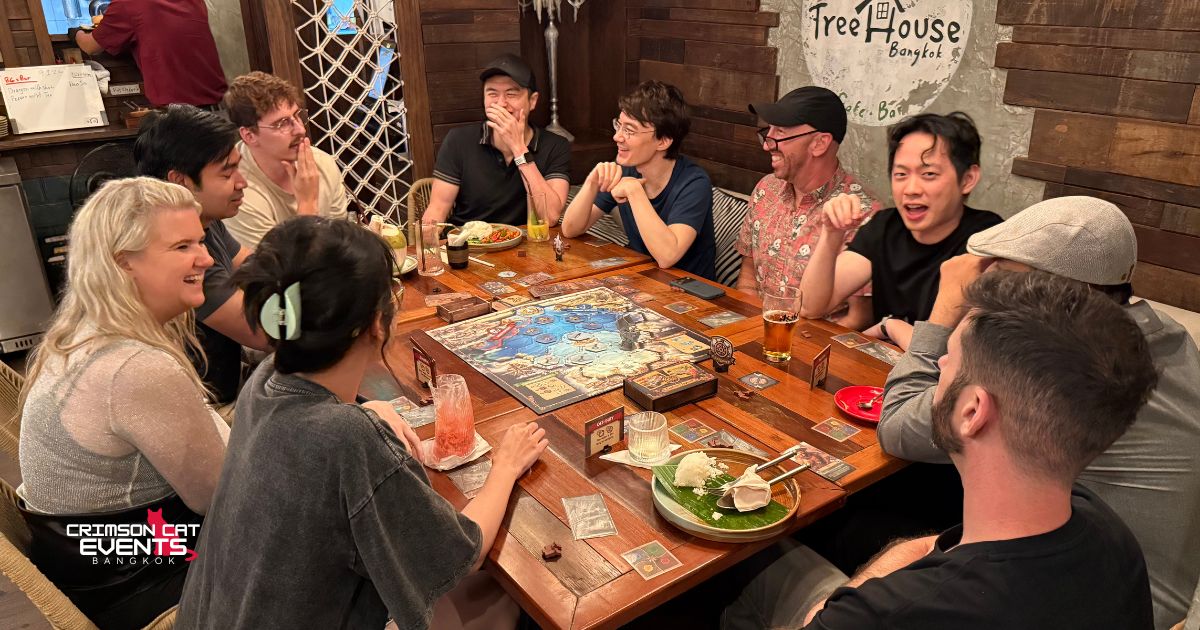 A table mid-game, laughing, at a Crimson Cat Game Night