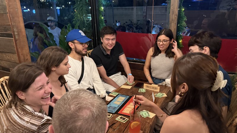 Friends laughing over a board game at Game Night